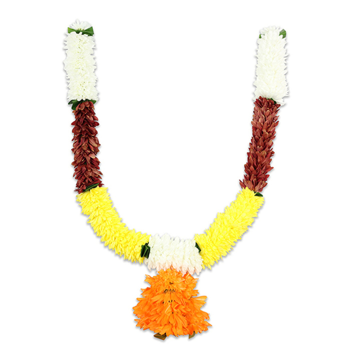 This U-shaped decorative mala hangs photographed on a plain white field, every section composed to read clearly and beautifully to the viewer. Starting from the small hanging loops, dense groups of soft, creamy-white florets form the topmost anchors, their rounded textures suggesting silky artificial petals that glow under bright light. Below these, a ribbon of deep reddish-brown elements creates a strong, almost sculptural middle band - the pieces appear as layered, slightly flattened petals or mock-dried foliage that bring a warm, grounding note. The arms then sweep into a generous expanse of vivid yellow clusters, arranged with the lively, pom-pom density of marigolds; the yellow is bright and optimistic, dominating the U with a sense of abundance and cheer. Delicate green accents interrupt the transitions, placed where sections meet to mimic leaf sprigs or ribbon ties and to add structural clarity. Anchoring the composition is a pronounced central pendant: a full, multi-layered bloom of vibrant orange ruffles that hangs from the lowest point, its texture lush and slightly frayed in a way that suggests movement and fullness. The piece is unmistakably celebratory and traditional, designed for religious puja, Diwali, Ganesh Chaturthi, or wedding entrances, but made from durable artificial materials so it endures through seasons. Locally this type of toran is a familiar sight at Grove Park community gatherings and can be hung in doorways or over home altars to lend an immediate, sunny sense of welcome.