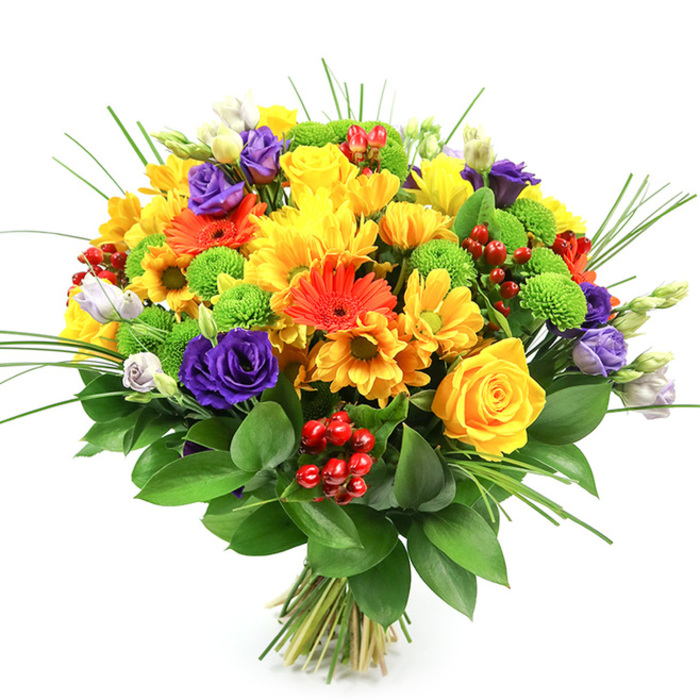 This image shows a vibrant, carefully constructed bouquet set against a simple white background, allowing every hue and texture to feel immediate and clear, as though you were standing in Grove Park Florist watching it being tied. The bouquet is distinctly round and dense, a dome of colour that radiates joy. Dominating the palette are happy yellows: tightly curled yellow roses, lush chrysanthemum heads, and smaller daisy-like blooms that together create a sunlit foundation. Interwoven among them, bright orange gerbera daisies and tangerine daisy flowers add bold splashes of colour, their open, graphic faces lending a contemporary flair that suits birthdays, congratulations, or a bright thank-you for a neighbour along Burlington Lane. Deep purple lisianthus blooms slip between these warm tones, their petals layered like delicate silk, while a few lavender-tipped and white buds soften the contrast and hint at new blossoms to come. Adding a playful rhythm, lime-green button chrysanthemums dot the design like small pom-poms, bringing a zesty freshness reminiscent of the green verges and trees lining the roads around Grove Park. Tucked here and there, small clusters of glossy, ruby-red hypericum berries introduce a festive sparkle and a unique, bead-like texture that draws the eye deeper into the arrangement. Slender, spiky blades of ornamental grass extend upwards and outwards, giving an impression of height and movement, as though caught in a light river breeze from the Thames. A broad base of dark, glossy foliage encircles the bouquet, grounding the vivid flowers and shaping the dome. The visible stems are neatly tied, ready for hand delivery across Grove Park, to rest on a dining table, office desk, or bedside, radiating warmth, optimism, and a sense of well-tended abundance.
