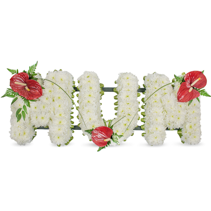 A poignant, hand-crafted memorial piece reads MUM in elegant, freestanding capital letters, photographed on a clean white background that allows every detail to be read clearly. The body of each letter is densely covered with pristine white spray chrysanthemums - small, rounded blooms packed so tightly they form a soft, voluminous texture that feels both substantial and tender. Under gentle natural light the chrysanthemums' layered petals create a muted glow, while shadow between clusters lends a delicate contour to the lettering. To introduce warmth and a single note of bold affection, three glossy red anthuriums are artfully placed: one on the upper left sweep of the first M, another cradled at the base of the U, and a third resting on the upper right of the final M. Each anthurium's polished spathe and pale yellow spadix stand out against the matte whites, and they are cushioned by rich green foliage - feathery ferns, broader leaves and slender, arching grass blades - which add depth and a soft botanical edge. Thin green stems or blades curve between the red flowers, visually linking them and drawing the eye across the letters. A subtle dark green structural frame peeks from behind the blooms, keeping the composition crisp and freestanding. Crafted by experienced local hands at Grove Park Florist, this classic sympathy tribute offers a clear, reverent expression of love and remembrance suitable for funerals, wakes or graveside gatherings near Chinbrook Meadows, Baring Road or around Grove Park station.