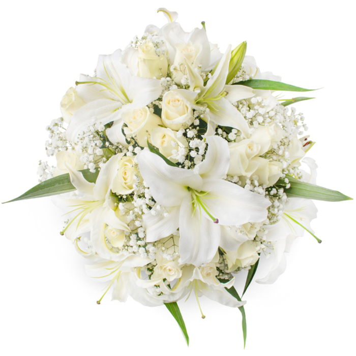 Captured in a crisp top-down view, this meticulously assembled round bouquet reads as an emblem of understated luxury. Several broad-petalled white lilies form the arrangement's focal points - their smooth, white surfaces folding back to reveal pale green stamens and a subtle hint of depth at each centre. Between and beneath those lilies sit dozens of cream and ivory roses, many still in tight bud or gently unfolding, their dense, velvety petals building a soft, tactile mass that complements the lilies' sculptural shapes. Interlaced through the larger blooms are delicate clusters of white Baby's Breath (Gypsophila), whose minute blossoms create a lace-like fill that breathes lightness into the bouquet. Fresh green leaves appear sparingly along the edges, their bright tones emphasizing the whiteness of the flowers and anchoring the composition with natural contrast. The arrangement's symmetry and compactness make it instantly readable as a bridal bouquet or an elegant centerpiece for a formal table, while its pristine colourway also suits memorial flowers and other solemn occasions. The combined fragrances - the lilies' clear, floral sweetness and the roses' richer, more intimate perfume - evoke the quiet emotion of important life moments. As a local florist who prepares flowers for celebrations and wakes around Grove Park and nearby Baring Road, I favour this kind of classic white palette when customers request something that feels both modern and respectfully traditional, an arrangement that can speak softly yet clearly on any occasion.