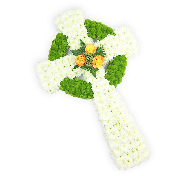 A solemn and beautifully balanced floral Celtic cross presented against a bright white field, photographed from a slightly elevated viewpoint to show its sculptural depth. The cross is constructed from dense groupings of pure white spray chrysanthemums, their small blooms pressed together to form a plush, pristine canvas that symbolizes purity and remembrance. Bright apple-green button chrysanthemums have been inserted with exacting rhythm to define the circular ring where the arms meet and to alternately ornament the horizontal arms; their vivid, lime-tinged tones produce a lively graphic line that enhances the Celtic motif. At the very centre rests a small cluster of three rich orange-yellow roses, their petals unfolding in warm layers that act as an emotional heart - like a soft sunrise within a field of white - and they are subtly framed by dark green fern or similar foliage to heighten contrast and depth. The arrangement's clean lines and restrained colour scheme evoke both spiritual reflection and cultural identification, gently recalling the green, white and gold often associated with Irish heritage or memorials. Soft, directional light highlights petal texture and form without drama, while the composition's three-dimensionality casts delicate shadow and gives real presence to the tribute. As a floral design suitable for funeral or memorial services, this cross would sit respectfully at a church near Grove Park or be delivered to the crematorium, offering consolation through expert arrangement, considered colour, and the quiet dignity of local floral craftsmanship.