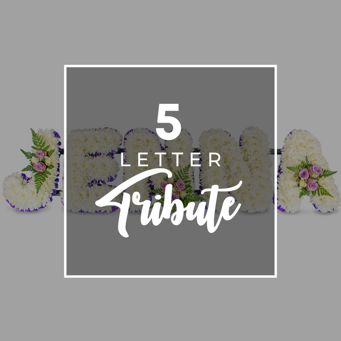 In this image, a refined five-letter floral letter tribute, intended for a funeral or memorial service, is displayed in a straight line on a soft, neutral grey background, giving the photograph a tranquil, understated elegance. Each letter stands distinct yet connected to the next, its shape entirely formed by tightly massed white chrysanthemums that create a thick, cushion-like surface, their petals overlapping in a delicate, snowy texture. Along the outer edges of every letter runs a neatly placed ribbon of deep purple satin, gently curved and pressed to the contours so that it frames the white blossoms, adding contrast and a measured sense of ceremony. The florist has introduced subtle colour and natural movement by nestling in small clusters of pale pink and muted mauve spray roses, accompanied by glossy green foliage and light, feathery fern tips that soften the formality of the design. The visible characters suggest the word JOHNA, with the J to the left and an A to the right, while O, H, and N are partially hidden beneath a central graphic panel, representing how any five-letter name or meaningful word can be created to honour a loved one. At the centre of the arrangement sits a square overlay in a slightly darker grey, outlined by a clean white border and carrying the text 5 LETTER Tribute in white, using a modern, uppercase sans-serif font for the first two words and a graceful script for Tribute. The overall impression is of a quietly beautiful, personalised piece such as a family in Grove Park might choose for a farewell service at a nearby church or crematorium, where the white flowers speak of remembrance and the purple ribbon brings a gentle note of reverence and love.