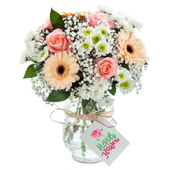 Envision waking to a bouquet of pastel treasures from Grove Park Florist, thoughtfully presented in a clear glass vase against a tranquil white canvas reminiscent of a sunlit Grove Park kitchen table. The plush peach-pink roses unfold their velvety spirals, forming the romantic heart of the composition. Flanking them, radiant peach gerberas with bold brown centers conjure warmth and joy with every glance, much like a stroll through nearby Duke's Meadows. Wispy clouds of baby's breath, featherlight and pure, weave among the blooms, lending a sense of softness and nostalgia. Interspersed white chrysanthemums, some with a flash of spring-green at their core, add fresh dimension and understated luxury. Subtle sprigs of eucalyptus complete the palette with natural greenery and a hint of woodland scent. A slim twine bow at the vase's neck, partnered with a minimalist white tag for your message, bestows a rustic, personalised touch. The clear vase reveals lush stems and water, reflecting the care and expertise of Grove Park's expert florists. Whether given as a gesture of love, comfort, or celebration, this bouquet brings an easy elegance to any Grove Park home, echoing the calm charm of the neighbourhood.