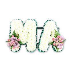 This image presents an elegant funeral flower arrangement spelling out the letters MA, a fitting tribute for a mother, mama, or cherished relative. Set against a plain white backdrop, the design allows each detail of the craftsmanship to be clearly seen. The capital M and A are fully packed with small white chrysanthemums, their tiny petals overlapping to create a smooth, uninterrupted surface. The flowers form a soft, almost velvety texture, inviting the imagination to picture how cool and gentle they would feel to the touch. The fresh white blooms symbolise respect, purity, and the stillness of remembrance, reminiscent of early morning light along the quiet roads of Grove Park. Outlining each letter is a ribbon of deep, glossy green satin, pleated into neat ruffles that trace the contours of the design. This dark border frames the white petals with a refined, tailored edge, helping the letters stand out clearly from every angle. At the bottom left of the M and the bottom right of the A, two coordinated posies bring in a tender wash of colour. Soft-pink roses, lilac roses, and tightly budded pink spray roses cluster together, their layered petals unfurling like shared stories and memories. Delicate fern fronds and pieces of lush greenery peek through the roses, adding movement and a light, natural feel. The combination of white and pastel tones creates a gentle, soothing mood, ideal for a funeral or memorial service near Grove Park, whether in a small local church or at a nearby crematorium. This MA tribute sits as a loving floral message, quietly expressing gratitude, affection, and enduring connection to the one who has passed.