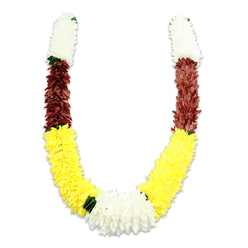 There is a quiet, measured dignity to this U-shaped mala, photographed on a pure white backdrop so every texture and shade reads clearly. Each arm begins with a dense, cylindrical cluster of creamy-white, chrysanthemum-like fabric flowers - their tiny, layered petals packed to form a soft, pillowed segment that suggests purity and calm. Immediately beneath this white crown, a compact band of deep maroon or reddish-brown blooms provides weight and earthiness, the tight petals catching light differently to create subtle depth. The garland then unfurls into a long, generous sweep of bright yellow flowers, their fluffier shapes composing the broad lower curve and bringing cheer and visual warmth. At the central bottom, where the yellow curves meet, a voluminous cluster of pure white blooms serves as a focal knot, balanced by small, dark green leaf-like separators that mark the transitions between colors. Though constructed from artificial fabrics for longevity, the craftsmanship is evident in the meticulous placement of each tiny petal and in the soft shadow the piece casts on the white surface. This is the kind of garland families in Grove Park and the surrounding neighbourhoods might choose for home puja, temple offerings, or wedding ceremonies - emblematic of purity, prosperity, and devotion. Prepared locally and intended for ceremonial use, it reads as both an object of respect and a piece of decorative tradition, reflecting the steady hand of a floral artisan who understands the rituals and seasons of the community - a piece you might see prepared by Grove Park Florist for a neighbourhood celebration.