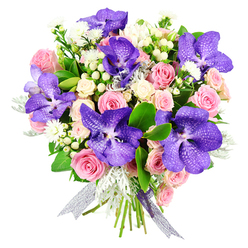 This elegant bouquet is captured against a spotless white background, creating the impression that it is suspended in light. At its heart are several large Vanda orchids, their petals a sumptuous mix of deep violet and blue, covered in intricate speckles that suggest delicate lace or fine porcelain. These striking orchids are cradled by an array of pastel pink roses, some in tight, promising buds and others fully bloomed, revealing concentric layers of soft petals that create a gentle, romantic texture. Creamy white spray roses are interwoven among the larger heads, their small clusters adding softness, volume, and a sense of movement. Fine sprays of tiny white flowers and clusters of pale hypericum berries slip between the roses and orchids, introducing dainty detail and rounded, bead-like shapes that catch the light. The greenery has been chosen to enhance the colours without overwhelming them: glossy dark leaves give the bouquet its structure and depth, while silvery-grey dusty miller brings a softly brushed, slightly frosted appearance that cools the overall palette. The stems are gathered neatly and tied with an iridescent silver-purple ribbon, its sheer fabric reflecting subtle hints of lavender and pearl, lending a final flourish of understated luxury. The bouquet feels both contemporary and timeless, the sort of arrangement that might be carried into a Grove Park home after a walk through nearby Chiswick House Gardens or delivered as a thoughtful gift for a milestone celebration along Grove Park Road. It carries an air of calm joy and heartfelt intention, ideal for birthdays, anniversaries, or simply saying, "You're cherished."