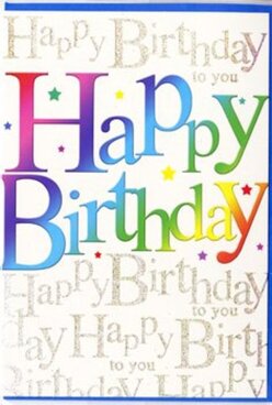 This photograph shows a birthday card that almost seems to sing "Happy Birthday" the way friends might gather to celebrate in a cosy Grove Park garden. The central focus is the phrase "Happy Birthday," spelled out in broad, curved letters that flow from left to right with a playful sense of movement. Each letter is filled with a rich gradient of colour-starting with deep reds and berry pinks, shifting into royal blues and lagoon greens, and finally softening into buttery yellows and pale golds. The transitions between shades are seamless, creating an airbrushed, velvety look that gives the impression of soft light playing across the text. Behind this main greeting, the card's entire background is covered in delicate, repeating lines of cursive writing that read "Happy Birthday to you." This script is rendered in shimmering gold ink, forming rhythmic rows that look like lines from a song written lovingly over and over. The metallic finish catches the light at different angles, similar to the gentle glint you see on leaves and railings along the paths toward Chiswick and the river. Dotted among the larger letters are tiny, colourful specks and star-like shapes, echoing the greeting's rainbow palette and suggesting scattered party confetti caught mid-air. The surface appears smooth with a soft sheen, like fine stationery you'd be pleased to touch. As someone at Grove Park Florist who often helps choose cards to accompany bright birthday arrangements for local delivery, I'd say this design captures that perfect blend of fun and elegance-a card that looks as joyful as the occasion it marks, while still feeling thoughtfully crafted and heartfelt.
