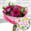A vibrant birthday flower and balloon gift set is displayed in soft natural light, as if resting on a kitchen table in a Grove Park townhouse. At the heart of the scene is a lavish bouquet arranged in a tall, clear glass cylinder vase, the stems visible through the water. Rich fuchsia and magenta gerbera daisies with velvety, almost black centres stand proudly at the front, their petals radiating outwards in crisp, perfect layers. They are surrounded by blush and mid-pink roses, some still tightly furled, others just beginning to open so that their spiralled petals suggest a gentle, romantic fragrance. Tiny clusters of deep purple filler flowers, likely statice, tuck themselves between the larger blooms, adding texture and depth. Lush green foliage, with a mix of broad glossy leaves and softer, more feathery greens, cradles the flowers and gives the arrangement a full, rounded shape. Around the neck of the vase, a length of rustic twine secures an off-white gift tag bearing a subtle rose-style logo, hinting at a premium florist's touch typical of a well-loved Grove Park flower shop. The base of the arrangement is wrapped in layers of crinkled, translucent pink cellophane, catching the light and creating a soft halo of colour around the stems. Just in front and slightly to the right, a shiny round foil balloon floats into view. Its white background is speckled with gentle grey dots and scattered with playful, colourful floral and circular designs in yellow, sky blue, lime green, hot pink, and violet. Across the centre, in bold pink script, the words happy birthday curve cheerfully, making the whole composition feel like a joyful surprise arriving for same-day birthday delivery somewhere off Grove Park Road.
