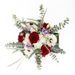 There is an effortless harmony to this floral arrangement, lovingly crafted at Grove Park Florist, making it feel both festive and soothing. Captured from a bird's-eye view on a pure white canvas, the bouquet's velvety red roses stand out with intensity, symbolizing deep affection and heartfelt connection. Frosty white gerbera daisies, each with a bold, chocolate center, bring a sense of light and levity, evoking cheerful gatherings in the heart of Grove Park. Dainty clouds of spray chrysanthemums lend a feathery softness, balancing the design with subtle, inviting texture. Gentle touches of lilac lisianthus weave in, their cool notes hinting at calm spring mornings spent strolling near Chiswick or Ravenscourt Park. Gracefully arching eucalyptus leaves in silvery green impart a refreshing modern twist, their scent faint but clean, like open windows on a breezy local afternoon. Slender green foliage provides the underlying structure, allowing every bloom its moment to shine. Flooded with clear, natural light, this bouquet offers both vibrancy and comfort-a perfect centrepiece for personal milestones, anniversaries, or joyful reunions, crafted with Grove Park's unique spirit and florists' attentive hands.
