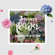 This image shows an artfully composed bouquet from a three-month flower subscription, presented with a relaxed elegance that suits the character of Grove Park. At its heart, rounded heads of blue hydrangea create generous pools of colour, their tiny petals overlapping in soft, powdery shades that suggest coolness and calm. Cradled among them are roses in gentle blush, lilac, and rose-pink tones, some fully open to reveal plush, layered centres and others still cupped, adding an intimate, romantic feel to the design. Slender stems of lisianthus flicker through the arrangement, tipping it with ruffled, bell-shaped blossoms and smooth buds, giving the bouquet vertical lift and a sense of lightness, as though the flowers have space to breathe. A collar of rich greenery encases the pastel blooms, with leaves of varying shapes and textures that bring depth and a fresh, garden-like quality, reminiscent of the foliage along the quiet streets and shared gardens near Grove Park station. The lighting is gentle and natural, falling from one side to illuminate the upper petals and cast faint, soft shadows that sculpt the bouquet's round, hand-tied form. The overall impression is of a calm, nurturing arrangement that could just as easily grace a sunny kitchen near Fauconberg Road as a cosy living room close to the river. You might imagine the subtle fragrance - a blend of soft rose, cool florals, and green stems - unfurling as you lift the bouquet from its wrapping. As part of a recurring subscription, this image suggests a comforting ritual: each month bringing another thoughtfully arranged selection of blues, pinks, and greens to brighten everyday moments and quietly mark the passing of the seasons in Grove Park.