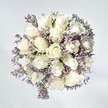 Infused with the soft calm found on early walks through Grove Park's green spaces, this bouquet exudes understated grace and heartfelt warmth. At the centre, lush white roses unfold in soft, creamy spirals, each petal a quiet celebration of fresh beginnings and sincere emotion. Airy sprays of pale lavender statice thread between the roses, adding an intricate, lace-like texture that suggests both elegance and tenderness. The background's gentle, white-washed tones amplify the purity of the arrangement, while natural daylight enhances the luminous freshness of every bloom, reminiscent of a sunny morning along Grove Park Terrace. Interspersed leafy greens lend structure and a sense of balance, creating a harmonious, inviting whole. When viewed from above, the composition reveals an artful spiral, thoughtfully crafted and effortlessly fluid. This bouquet radiates gentle optimism and composure-an ideal expression of sympathy, congratulations, or refined celebration, thoughtfully prepared to leave a lasting impression and bring a breath of Grove Park's serenity to its recipient.
