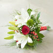 Displayed on a soft, light beige fabric that resembles finely woven linen, this elegant bouquet is positioned diagonally across the frame, as though it has just been set down by a bride after a ceremony in Grove Park. At its heart, large white oriental lilies unfurl gracefully, their trumpet-shaped blooms wide and welcoming, each petal lightly ruffled along the edge and touched with fine reddish speckles near the centre, giving them a quietly intricate charm. Some lilies remain as sleek green buds, tightly closed and upright, hinting at new life and allowing the bouquet to evolve over several days. Snuggled amid the white blooms, a single deep crimson red rose creates a powerful focal point, its velvety petals spiralling inwards with the precision and richness that symbolise enduring love and devotion. Adding a modern twist, two rounded Green Trick dianthus nestle within the greenery, their bright green, fuzzy surfaces reminiscent of soft moss and offering an engaging contrast to the smooth lily petals. Tiny stars of gypsophila, or baby's breath, are scattered delicately through the arrangement, adding airiness and a gentle romantic haze. Clusters of glossy, ruby-red hypericum berries echo the hue of the rose and add a playful, slightly festive touch that works beautifully for winter weddings or special occasions around Grove Park. The bouquet is lushly framed with deep green foliage - broad, shiny leaves create a strong base, while slender, grass-like stems introduce movement and fine lines. All the stems are neatly gathered and wrapped with a wide, shimmering red satin ribbon, tied toward the bottom right and resting elegantly on the neutral fabric. The resulting composition feels refined yet heartfelt, ideal for wedding flowers delivered to Grove Park homes, riverside venues, or intimate celebrations nearby.