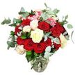 A lavish, romantically styled rose bouquet rises from a clear glass vase, photographed against a flawless white background that amplifies its colours and textures. The design is dominated by a wealth of deep red and bright scarlet roses, some in tight, bud-like forms full of promise, others fully open with velvety petals unfurling in generous layers. Between these rich, passionate blooms, roses in creamy white and ivory tones, along with a few with gently blush-tinted edges, nestle in thoughtfully, adding a calm, luminous quality that seems to soften the overall effect, like a quiet pause during an evening in Grove Park. Throughout the arrangement, small clusters of bright pink filler flowers peep out from between the larger roses, adding lively pops of colour and delicate texture that keep the bouquet from feeling too formal. Around and among the blossoms, eucalyptus stems with rounded, blue-green leaves arc gracefully, their soft, silvery surface giving the bouquet a contemporary edge and hinting at the cool, clean fragrance often associated with freshly cut eucalyptus foliage in local London flower shops. Dark green rose leaves and the occasional silvery-green accent leaf fill the remaining spaces, helping create a full, rounded silhouette that looks equally at home as a centrepiece on a dining table in Grove Park or as a grand romantic gesture delivered to a nearby riverside apartment. The vase, crystal clear with a gently bulbous base tapering towards the neck, holds the neatly arranged stems in visible water, reinforcing the impression of freshness and authenticity. With no distractions in the background, the viewer's attention is focused solely on the nuanced interplay of rich reds, soft whites, subtle pink touches, and cool green foliage, capturing the spirit of a carefully crafted, heartfelt bouquet.
