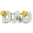 A dignified, three-dimensional sympathy tribute that spells DAD in large, freestanding capital letters, each letter hand-built from a dense, cloud-like carpet of pristine white spray chrysanthemums that read as calm and solemn at first sight. The soft, pillowy texture of the small white florets is crisply framed by a ruffled dark green satin ribbon running around each letter's outer and inner edges, the ribbon catching soft studio light and giving a satin sheen that crisply defines the rounded shapes. Behind the letters, thin dark green metal support bars peek through at horizontal intervals, a discreet, sturdy armature that ties the three pieces into a single memorial display. Bright clusters of sunlit yellow roses sit like warm beacons on the outer curves of each D, the roses in full bloom with layered petals and a faint honeyed scent, each cluster nestled with delicate white freesias and compact greenery. A pair of deep purple to burgundy calla lilies forms an elegant focal on the lower diagonal of the A, their smooth, trumpet silhouettes introducing a quiet, reverent contrast to the cheerful yellow. Two long, bare green stems arch from the left cluster toward the middle, drawing the eye inward and adding a graceful line of movement across the composition. The overall impression is one of careful restraint and heartfelt workmanship, a floral message of love and remembrance intended for funeral or memorial use. Prepared with neighbourhood care for families in Grove Park, Lewisham and nearby Hither Green, this tribute reads as a calm, composed farewell in both sight and scent.