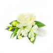 Set against a clean white backdrop, this refined corsage or boutonniere reads as a study in soft whites and deep greens, expertly balanced for a wedding or formal evening. The eye is immediately drawn to a single, fully opened creamy white rose at the centre - its velvety petals layered tightly at the heart and unfurling outward with subtle shadow and sheen that suggest a cool, dewy touch. Surrounding the rose are slender, lily-like alstroemeria blooms whose elongated ivory petals open with delicate, painterly veins; to one side a couple of slim green buds promise more blooms to come. Nestled beneath and between the larger flowers are tiny white daisy-like florets with pale yellow centres, their miniature faces lending a cheerful, countrified detail that softens the corsage's formality. A foundation of deep, broad green leaves forms a lush cradle for the arrangement, the foliage's glossy texture contrasting with the petals' matte softness. On the right-hand edge, a small cluster of lustrous white pearls is tucked among the leaves like a string of quiet jewellery - an elegant nod to bridal tradition. The piece was styled to sit close to the lapel or around a wrist, its composition and weight carefully considered so it reads as light and graceful. For those in Grove Park and the surrounding neighbourhoods such as Hither Green and Lee, this corsage captures a gentle, hopeful mood - pure in colour, tactile in detail, and perfect for vows, prom, or any occasion that calls for quiet elegance.