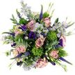 The bouquet in this image is shown from above, resting on a bright white surface that highlights its rich blend of colours and textures, much like a floral still life created for a Grove Park townhouse. Large, fully open roses in soft blush, dusty pink, and mauve form the main focal points, their layered petals curling outward in gentle spirals that speak of romance and care. Nestled between them are airy clusters of small lavender aster-like flowers with vivid yellow centres, adding a touch of brightness and playfulness, like tiny wildflower stars scattered along the Thames Path. Deep purple lisianthus blooms and buds thread through the composition, bringing velvety depth and a slightly more dramatic tone that complements the softer pinks. Graceful stems of purple veronica stand tall, their slim, spiky flowers adding vertical rhythm and a sense of natural, slightly untamed movement, as though the bouquet had just been gathered from a riverside meadow. Dotted among the petals are round, cushiony balls of brilliant chartreuse green, reminiscent of Green Trick dianthus or textured viburnum, whose almost moss-like texture adds a distinctly modern, sculptural touch. Cool eucalyptus foliage in silvery green sweeps around and through the flowers, creating a soothing backdrop and suggesting a refreshing, herbal scent when the bouquet is lifted. Additional greenery completes the design, ensuring every space is gently filled so the arrangement feels lush, abundant, and thoughtfully composed. The overall mood is elegant yet relaxed, ideal for birthdays, anniversaries, or simple moments of appreciation, with local delivery bringing this touch of botanical beauty to homes and offices throughout Grove Park and nearby Barnes.
