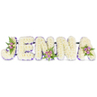 A profoundly tender, three-dimensional name tribute reads JENNA in soft, snow-white chrysanthemums arranged as bold capital letters against a pristine white backdrop. Each letter is built from dense, cloud-like clusters of small creamy florets so closely packed they form a seamless, velvety surface; the petals catch a gentle, diffused light that suggests early-morning calm and quiet reflection. A narrow purple trim follows the inner edges of every letter - a delicate ribbon-like outline of deep violet and lilac that gives each character definition and a subtle, dignified contrast to the creamy whites. Three petite accent bouquets punctuate the composition: one nestles into the curve of the J, another anchors the lower centre of the first N, and a third graces the upper right of the final A. Each accent is composed of soft pink and lavender spray roses, tiny cream buds, and feathery dark-green fern fronds, adding whispering notes of colour, fresh leaf perfume, and natural texture among the white sea. Thin, dark metal bars run horizontally behind the letters, discreetly joining the sequence into a single, stable tribute and suggesting the careful structural work of a professional florist. Intended as a sympathetic memorial piece for a funeral or celebration of life, the arrangement communicates respect, love, and remembrance through its simple palette and considered details. Crafted with local care in Grove Park and suitable for placement at a wake or chapel service, it radiates calm and thoughtful craftsmanship while remaining quietly beautiful and comforting to grieving families.